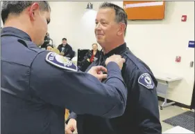  ?? PHOTO COURTESY CITY OF IMPERIAL ?? New Interim Chief of Police for the City of Imperial, Michael Crankshaw (right), gets his new badge pinned on his uniform by his son, El Centro Police Department officer Daniel Crankshaw (left), during an Imperial City Council meeting, Wednesday, March 1, in Imperial.