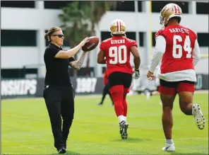  ?? MICHAEL REAVES/GETTY IMAGES/TNS ?? Offensive assistant coach Katie Sowers of the San Francisco 49ers runs a drill during practice for Super Bowl LIV at the Greentree Practice Fields on the campus of the University of Miami on Jan. 31 in Coral Gables, Fla.