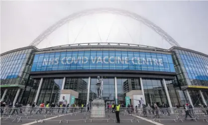  ?? Photograph: Xinhua/REX/ Shuttersto­ck ?? People queue outside the NHS (National Health Service) Covid Vaccine Center at Wembley Stadium in London.
