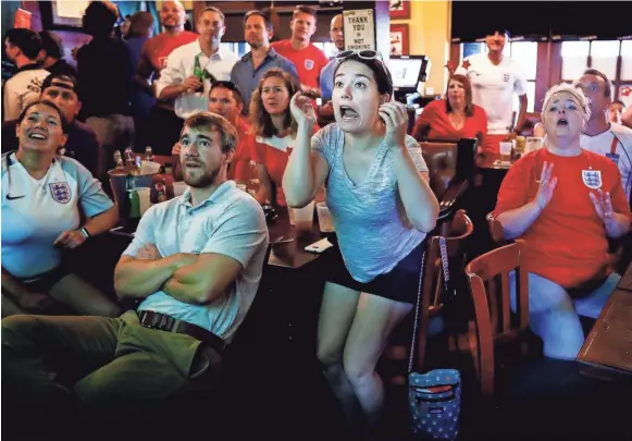  ??  ?? English National Soccer team fan Kate Schuhlein (middle) reacts after a missed goal attempt against Croatia, while fans enjoy the World Cup match at Celtic Crossing. MARK WEBER /THE COMMERCIAL APPEAL