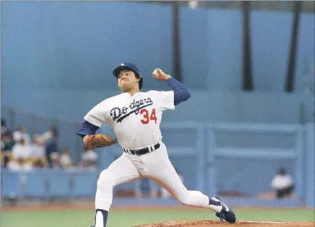  ?? Lennox McLendon Associated Press ?? FERNANDO VALENZUELA, pitching the 1985 opener against the St. Louis Cardinals, is still revered not only by fans but by current Dodgers. “When you start playing for the Dodgers, that’s one of the first things you learn, just the impact Fernando had,” Max Muncy said.