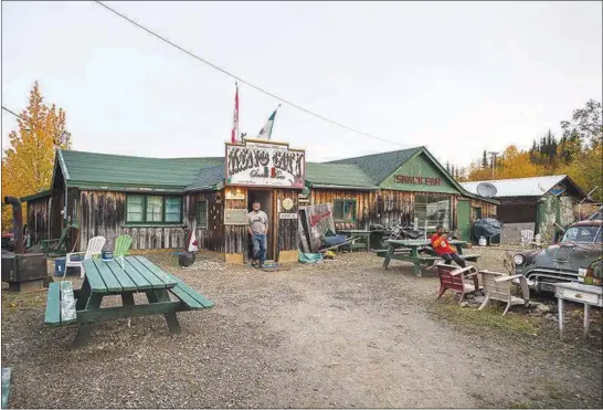  ?? PHOTOS BY AARON VINCENT ELKAIM / THE NEW YORK TIMES ?? Mike Mancini stands in the doorway of his restaurant, the Keno City Snack Bar, Sept. 14 in Keno City, Yukon Territory. While this faded Yukon gold rush town has seen prospector­s, prostitute­s, miners and bootlegger­s come and go, it serves as a lesson on...