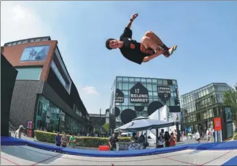  ??  ?? An outdoor sports enthusiast tests the trampoline at the Banff China film festival on May 20 in Beijing.