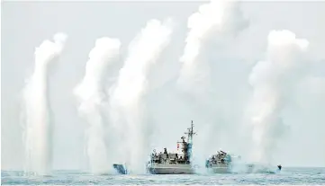  ?? — Reuters photo ?? Flares are set off from Fong Yang (FFG-933) Chi Yang class frigate (Knox class) during a drill near Yilan naval base,Taiwan.