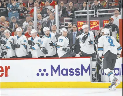 ?? Paul Beaty The Associated Press ?? Left wing Evander Kane, right, celebrates with Sharks teammates after a March 11 goal versus Chicago.