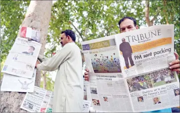  ??  ?? A Pakistani man reads a newspaper with front page news of ousted Pakistani Prime Minister Nawaz Sharif in Islamabad. — AFP photo
