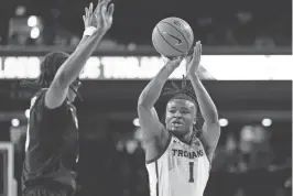  ?? KYUSUNG GONG/AP ?? Southern California guard Isaiah Collier shoots over Colorado forward Cody Williams during the first half on Saturday in Los Angeles.