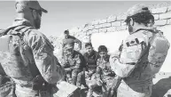  ?? RYAN REMIORZ / THE CANADIAN PRESS FILES ?? Canadian special forces soldiers speak with Kurdish fighters in 2017 in northern Iraq. Up to 250 Canadian troops will be part of a new NATO mission in Iraq.