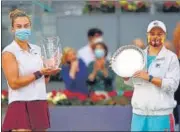  ?? AFP ?? Belarus' Aryna Sabalenka (L) poses with her trophy after beating Australia's Ashleigh Barty in the Madrid Open final.