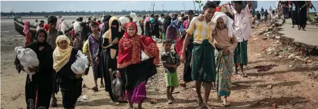  ??  ?? Rohingya after arriving on a boat to Bangladesh yesterday in Shah Porir Dip. Photo: Allison Joyce/Getty Images