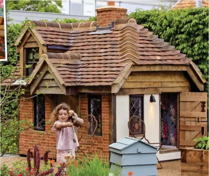  ??  ?? At home: Rose, four, tends to the plants at the playhouse designed by her mother Nadine