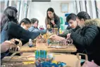  ??  ?? An IYP member assists a family workshop on Slow Boat, April 2018.