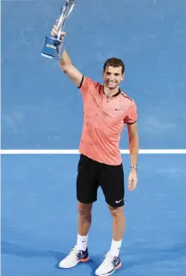  ??  ?? BRISBANE: Grigor Dimitrov of Bulgaria holds the trophy after winning the final match against Kei Nishikori of Japan at the Brisbane Internatio­nal tennis tournament in Brisbane, Australia, yesterday.— AP