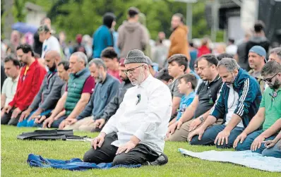  ?? GEOFF ROBINS THE CANADIAN PRESS ?? A group of men pray during a ceremony and march for the Afzaal family in London, Ont., on Sunday. The march was to honour the Muslim family mowed down one year ago by a pickup truck driver while they took an evening walk.