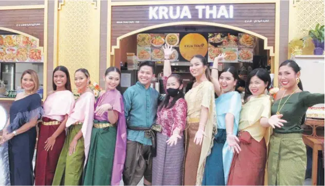  ?? John Varughese/gulf Today ?? ↑ Mother and son chef-entreprene­urs Sajai Waiyakrutt­ha (6th from left) and Paul Chaipreech­achot (5th from left) at the inaugurati­on of their own Krua Thai (Thai Kitchen) booth at the Thai Souk in Souk Al Marfa, Deira Islands, Dubai on Saturday afternoon.