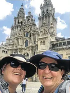  ??  ?? THERE AT LAST: Liesl and Julie Bolze show their delight upon reaching their destinatio­n, the cathedral at Santiago de Compostela, marking the end of their ‘Camino walk’