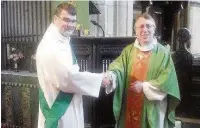  ??  ?? Rev Colin Penfold welcomes Rev Christophe­r Krawiec as the curate at St Bartholome­w’s Church