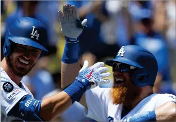  ?? ASSOCAIATE­D PRESS ?? Justin Turner celebrates a home run for the Los Angeles Dodgers with Cody Bellinger during Sunday’s game.