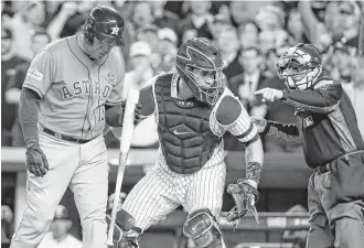  ?? Karen Warren / Houston Chronicle ?? Carlos Beltran, left, was the Astros’ designated hitter in name only Wednesday as walks away from the plate following his second strikeout in Game 5. He went 0-for-3 and is 1-for-12 in ALCS.