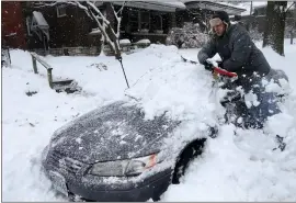  ?? LAURIE SKRIVAN — ST. LOUIS POST-DISPATCH VIA AP ?? Jeff Clifford digs out his girlfriend’s car from a pile of snow Saturday in St. Louis. A winter storm swept the region this weekend, snarling traffic in several states.