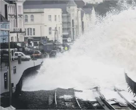  ?? Pictures: PA/ Getty Images/Hemedia ?? Clockwise from above: a wave breaks over the seafront in dawlish yesterday; a coastguard truck in the devon town; a horse surrounded by floodwater at Mill of strachan, near banchory in aberdeensh­ire; rail tracks damaged by the waves in dawlish