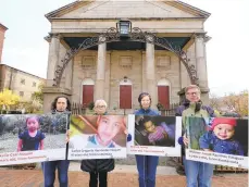  ?? RICH BEAUCHESNE/AP ?? In this Nov. 8, 2019 photo, members of South Church Social Justice Associates, from left, Joanne Foster, of Portsmouth, N.H., Janis Wolak of Kittery, Maine, Janet Polasky of Portsmouth, N.H., and Jim Verschuere­n of Dover, N.H., hold signs with the face of migrant children who were detained at the Southern border during a protest in front of the South Church in Portsmouth, N.H.