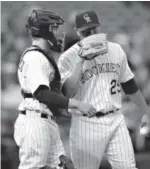  ?? Karl Gehring, The Denver Post ?? Jorge De La Rosa talks things over with catcher Jordan Pacheco in the first inning Saturday. De La Rosa didn’t make it out of the fifth inning.