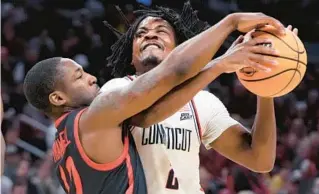  ?? MICHAEL DWYER/AP ?? San Diego State guard Darrion Trammell, left, tries to stop UConn guard Tristen Newton during their Sweet 16 matchup on Thursday in Boston.