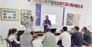  ??  ?? ATHENS: Refugees, who are to be relocated to Portugal, attend an informatio­n session at the premises of the Internatio­nal Organizati­on for Migration (IOM) on Nov 9, 2016.