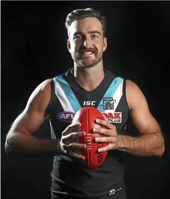  ?? PHOTOS: SARAH REED & CAMERON SPENCER/GETTY ?? LOVING IT: Charlie Dixon has become a key player at Port Adelaide. Inset: Dixon celebrates with fans after the Power’s win over the Sydney Swans last Sunday.