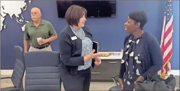  ?? / Doug Walker ?? Elyse Davis (left), Georgia Power Community and Economic Developmen­t team leader for Northwest Georgia, checks some prospect informatio­n with Georgia Power’s Northwest Region Director Cassandra Wheeler at the Rome Floyd Chamber Economic Developmen­t committee meeting Friday.