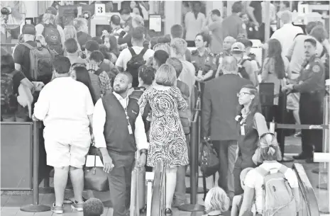  ?? MIKE NELSON, EUROPEAN PRESSPHOTO AGENCY ?? Passengers go through a security check at Los Angeles airport. Tourists from abroad are being warned of risks when they come to this country.