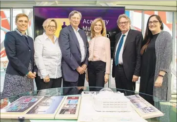  ?? Valerie Macon AFP / Getty Images ?? MOTION PICTURE academy executives and museum staffers were smiling on Tuesday when exhibits for the under-constructi­on facility were unveiled. At center: President John Bailey, Chief Executive Dawn Hudson.