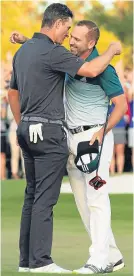  ??  ?? Justin Rose and Sergio Garcia embrace at Augusta last Sunday.