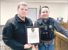  ?? Westside Eagle Observer/RANDY MOLL ?? Highfill police officer Dennis Malone (left) received a commendati­on from Highfill police chief Blake Webb at the city council meeting in Highfill on Dec. 10 for his quick response and ongoing investigat­ive work in locating and recovering two juveniles who ran away from the Northwest Arkansas Children’s Shelter on Nov. 24. Webb said Malone coordinate­d efforts with other law-enforcemen­t agencies across the state and went above and beyond to serve and protect the citizens of Highfill. The commendati­on was also signed by Michelle Rieff, Highfill’s mayor.
