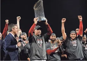  ?? GARY A. VASQUEZ/USA TODAY SPORTS ?? Red Sox manager Alex Cora hoists the Commission­er’s Trophy after winning the World Series last year.