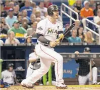  ?? BRYAN CEREIJO/TNS ?? Miami’s Justin Bour hits a single in the first inning, driving in two runs against the New York Mets on Tuesday in Miami.