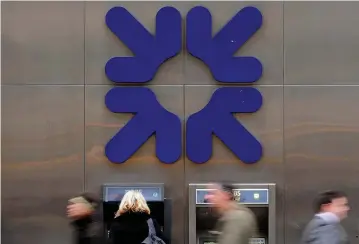  ?? (Toby Melville/Reuters) ?? A WOMAN USES an ATM at a Royal Bank of Scotland (RBS) branch in London.