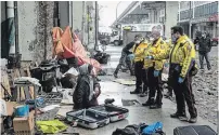  ?? CHRIS YOUNG THE CANADIAN PRESS ?? Police officers speak to a homeless person as city workers clear an encampment on Toronto's Bay Street.