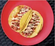  ??  ?? The delightful corn tortillas are stuffed with chicken, black beans, fontina, pice de gallo and chipotle cream.