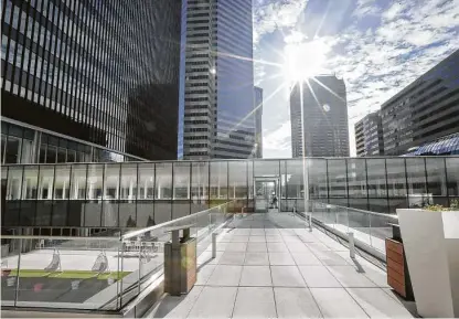  ?? Photos by Steve Gonzales / Staff photograph­er ?? An outside walkway leads to an indoor walkway area at Houston Center, downtown’s largest office complex, which has just completed an extensive renovation.