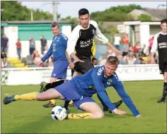  ??  ?? Wicklow Town’s Thomas Kelly protects the ball from Sean Heffernan.