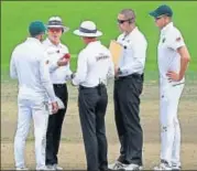  ?? GETTY ?? Umpires Bruce Oxenford (left) and Rod Tucker discuss the state of the ball with Proteas captain Faf du Plessis on Monday.