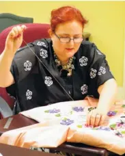  ??  ?? Patricia Gordon, an arts assistant at the Heritage House, works on a project.