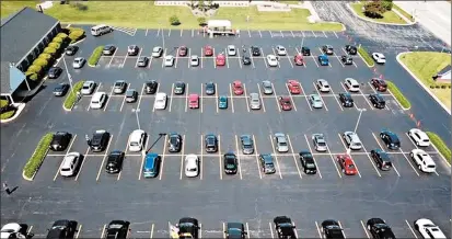  ?? DANWERNER ?? A drone captures a drive-in service — with cars spaced accordingl­y — May 24 outside of Sauk Trail Baptist Temple in Richton Park.