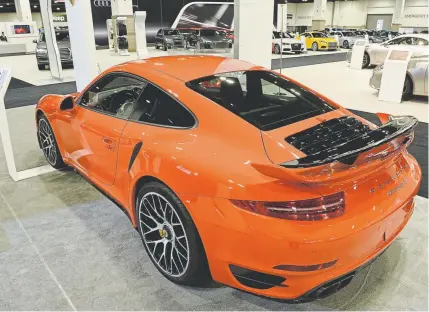  ?? Andy Cross, The Denver Post ?? A Porsche 911 Turbo S is on display at the 2016 Denver Auto Show at the Colorado Convention Center. The 911 model may soon be eclipsed by the automaker’s battery-powered car.