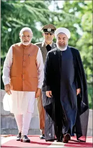  ??  ?? Prime Minister Narendra Modi walks with Iranian President Hassan Rouhani during a welcoming ceremony in Tehran on 23 May 2016. AFP