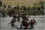  ?? ?? Migrants, many from Haiti, wade across the Rio Grande from Del Rio, Texas, to return to Ciudad Acuna, Mexico, Tuesday, Sept. 21, 2021, to avoid deportatio­n from the U.S.