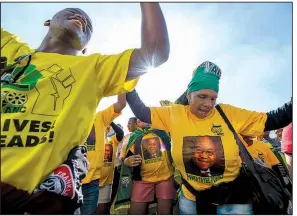  ?? AP file photo ?? African National Congress members rally earlier this year in Cape Town in support of South African President Jacob Zuma, who faces corruption allegation­s.