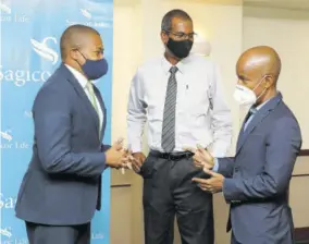  ?? ?? Willard Brown (right), executive vice-president, Sagicor Life’s Employee Benefits Division, engages Minister of Agricultur­e and Fisheries Floyd Green (left) and Dr Gavin Bellamy, CEO, National Fisheries Authority, in conversati­on during the symbolic signing ceremony for the Sagicor Agri-care Insurance Plan on Monday.